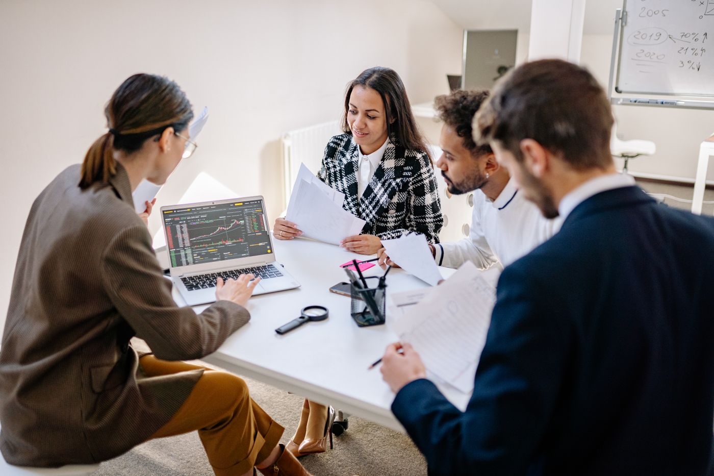 Business colleagues reviewing data together on a laptop