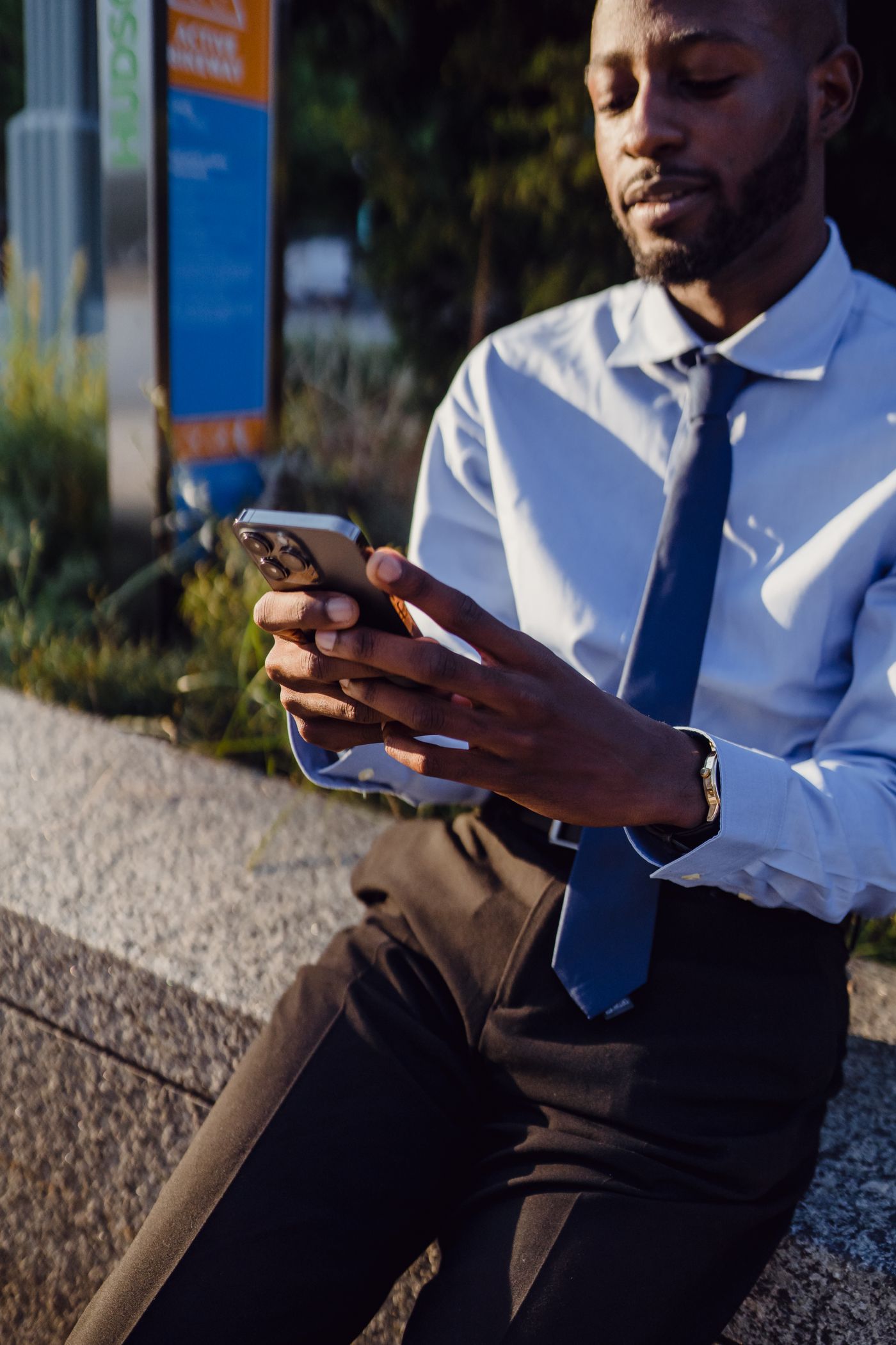 A business professional using a smartphone outdoors