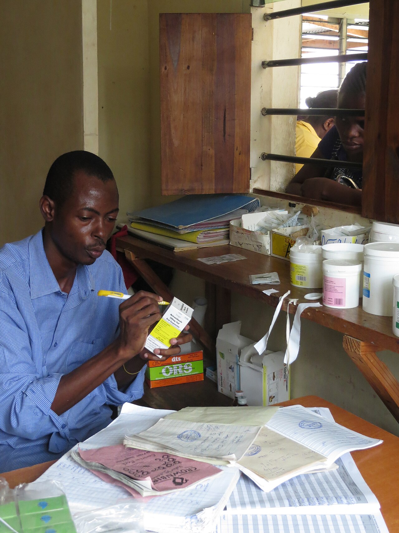 A pharmacy technologist preparing medicine in Mombasa, Kenya