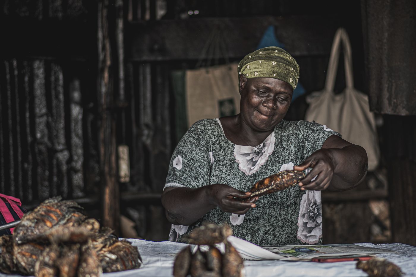 A small-business owner preparing produce at a Nairobi market stall